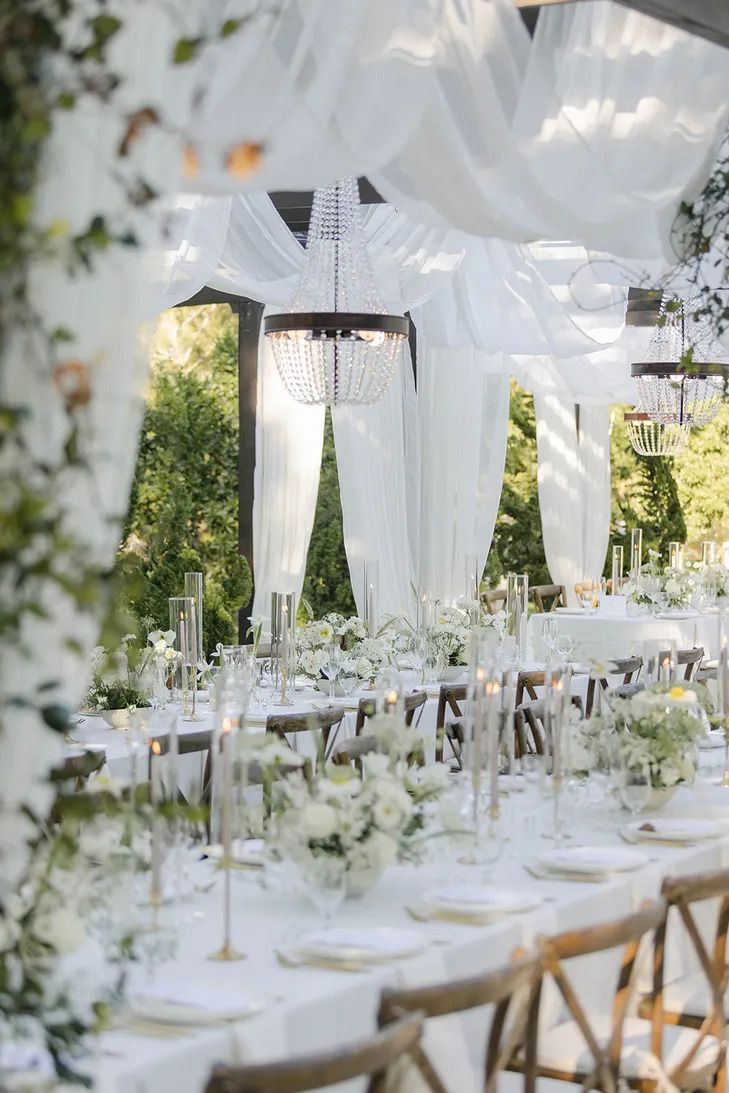 Table set for an outdoor celebration among flowers at sunset